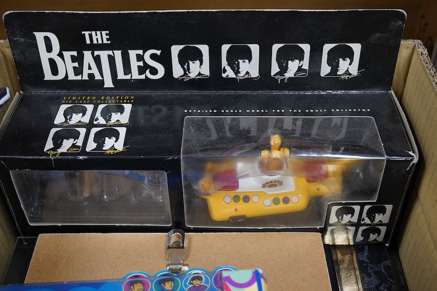 A collection of Beatles memorabilia including; models of a Beatles drum kit and eight miniature guitars and stands, each approx 25cm long, together with three boxed Corgi Beatles related models, including the Yellow Subm